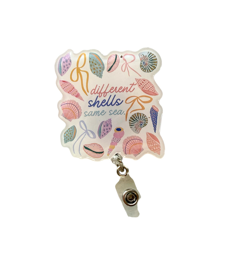 different shells same sea badge reel